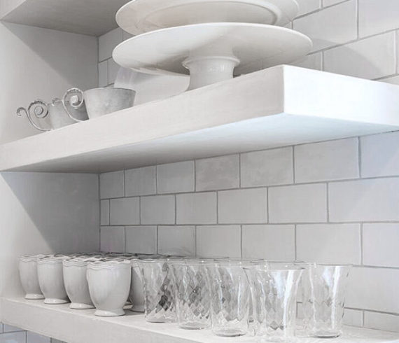 Kitchen storage. Open shelves displaying dishes and glassware.