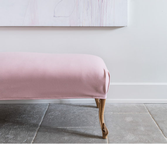 Slipcovered antique bench and contemporary art. Photographed by Michael Hunter.